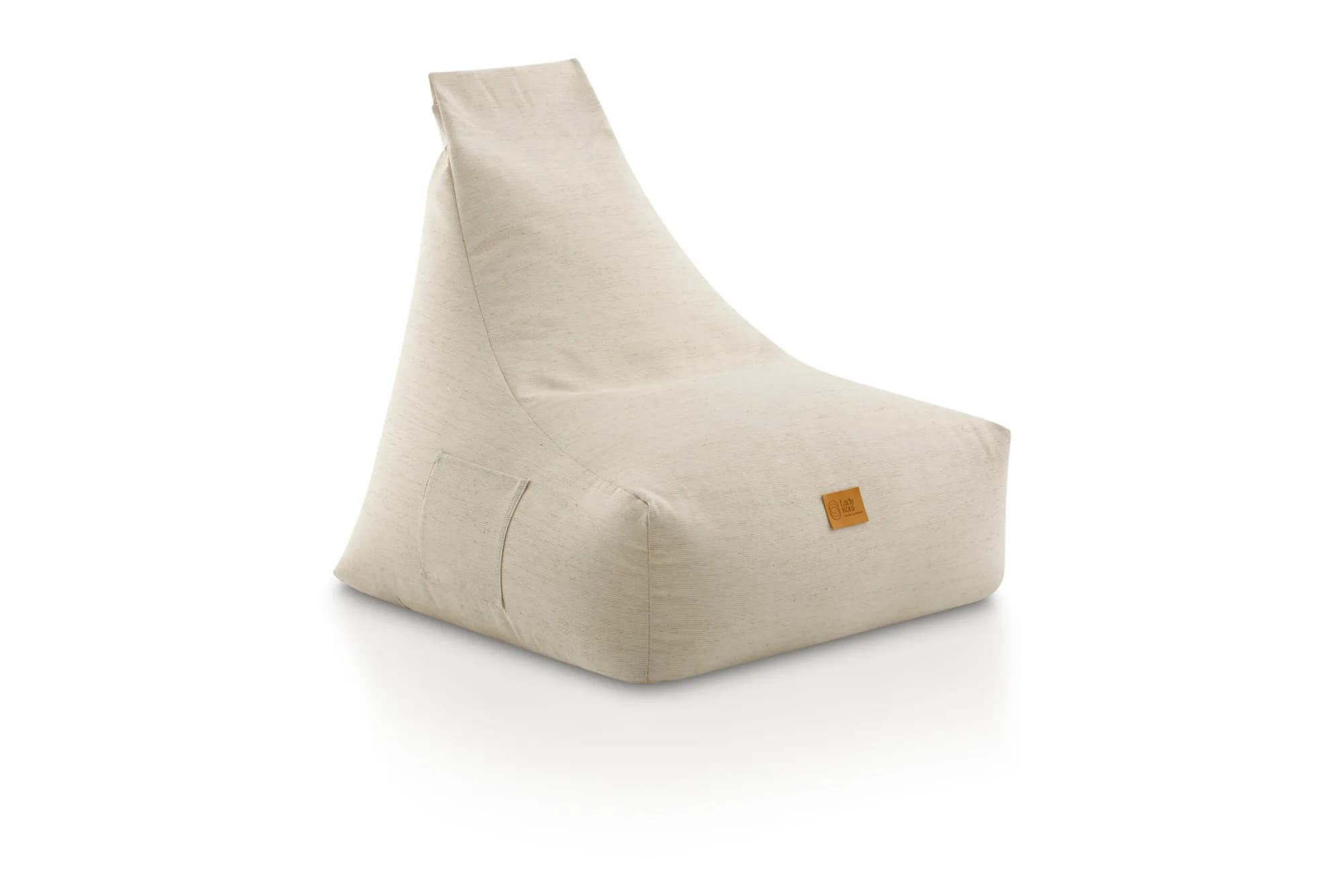 Puf sillón Lola tapizado en tejido natural, en un interior mediterráneo